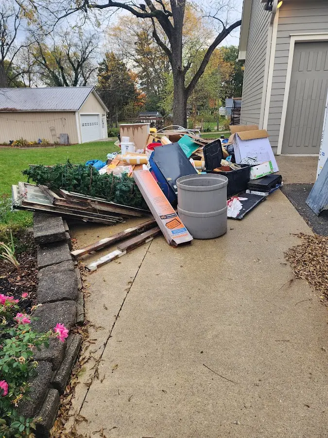 Dumpster being loaded with debris for Roofing Dumpster Rental in St. Peters